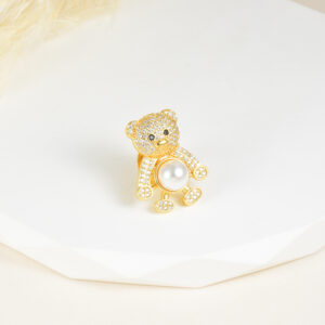 BROCHE . C/PERLA Y PIEDRAS EN BAÑO DE ORO