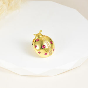 BROCHE . C/ PIEDRAS EN BAÑO DE ORO